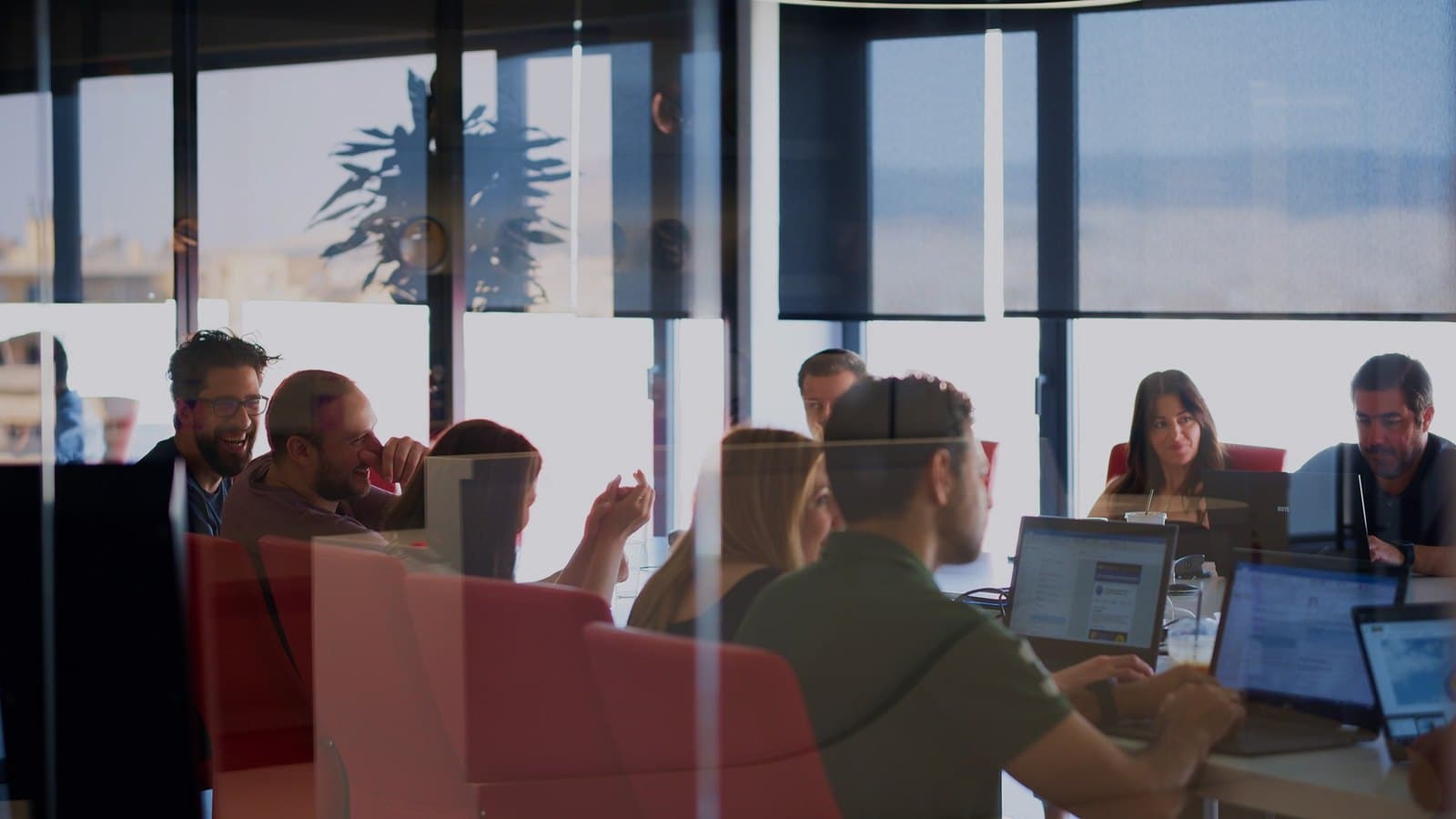 An ATCOM team working together in a meeting room