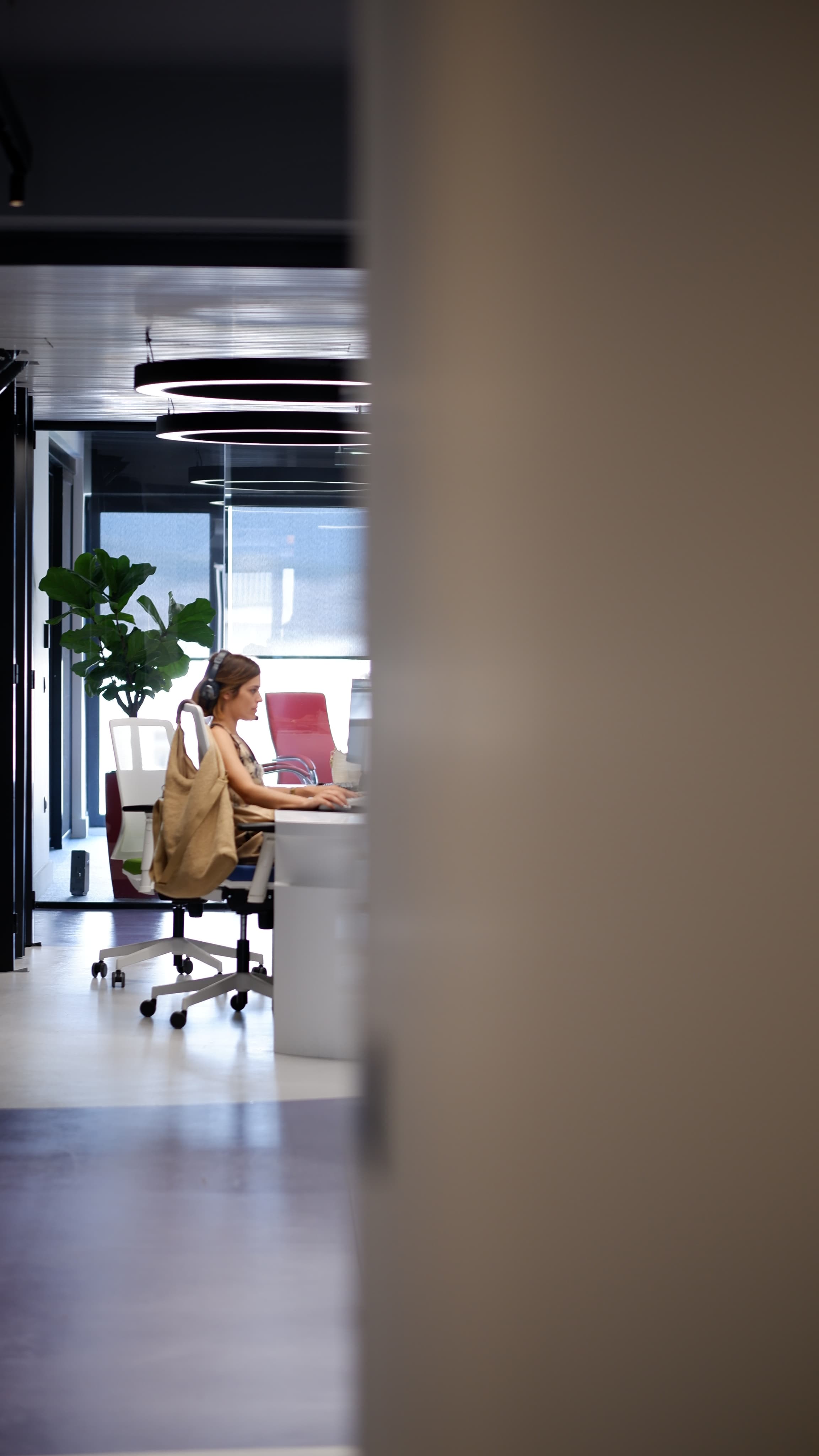 An ATCOM team member at a desk with headphones
