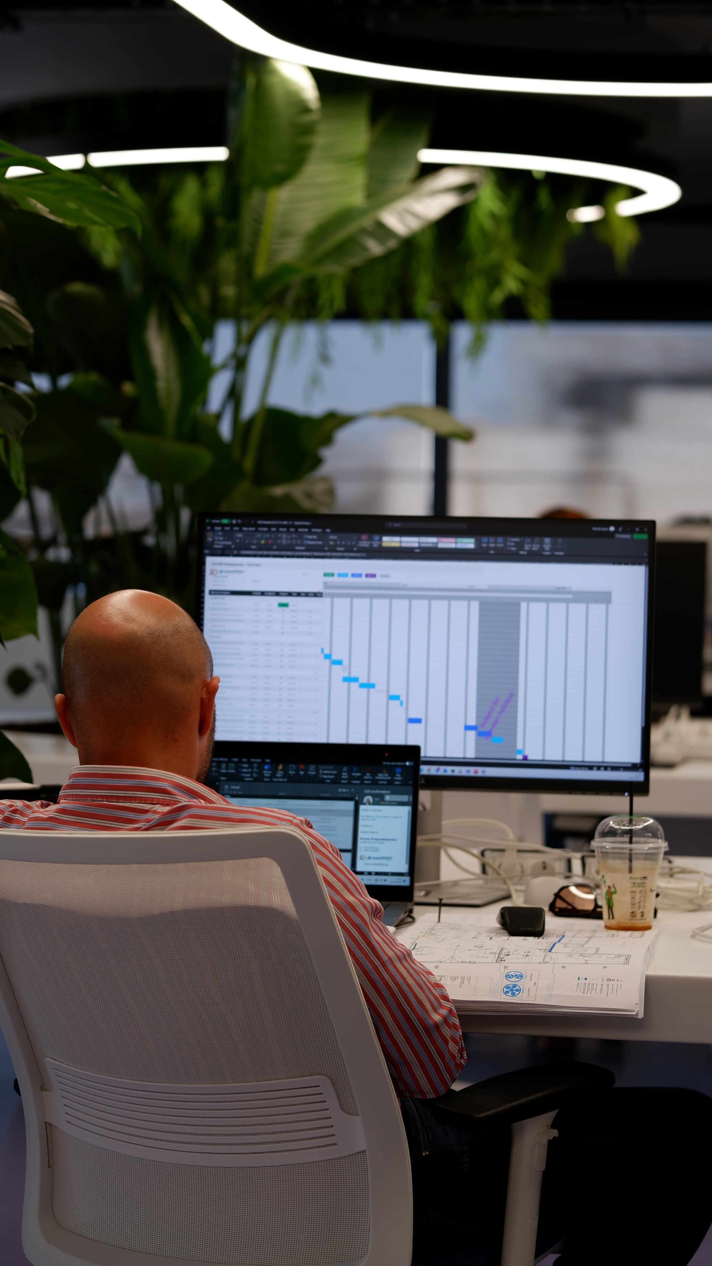 An ATCOM developer at a multi-monitor desk