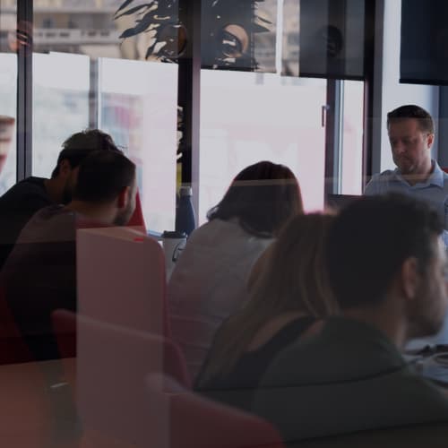 ATCOM team members in a meeting by the window