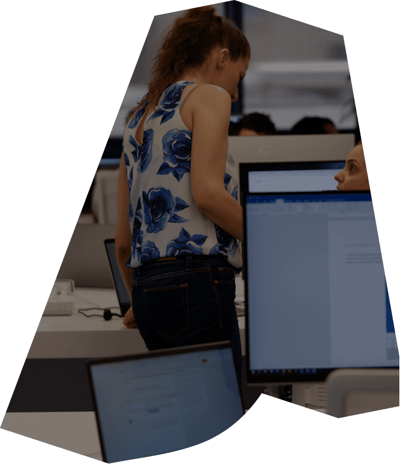 An ATCOM team member working at a developer workstation