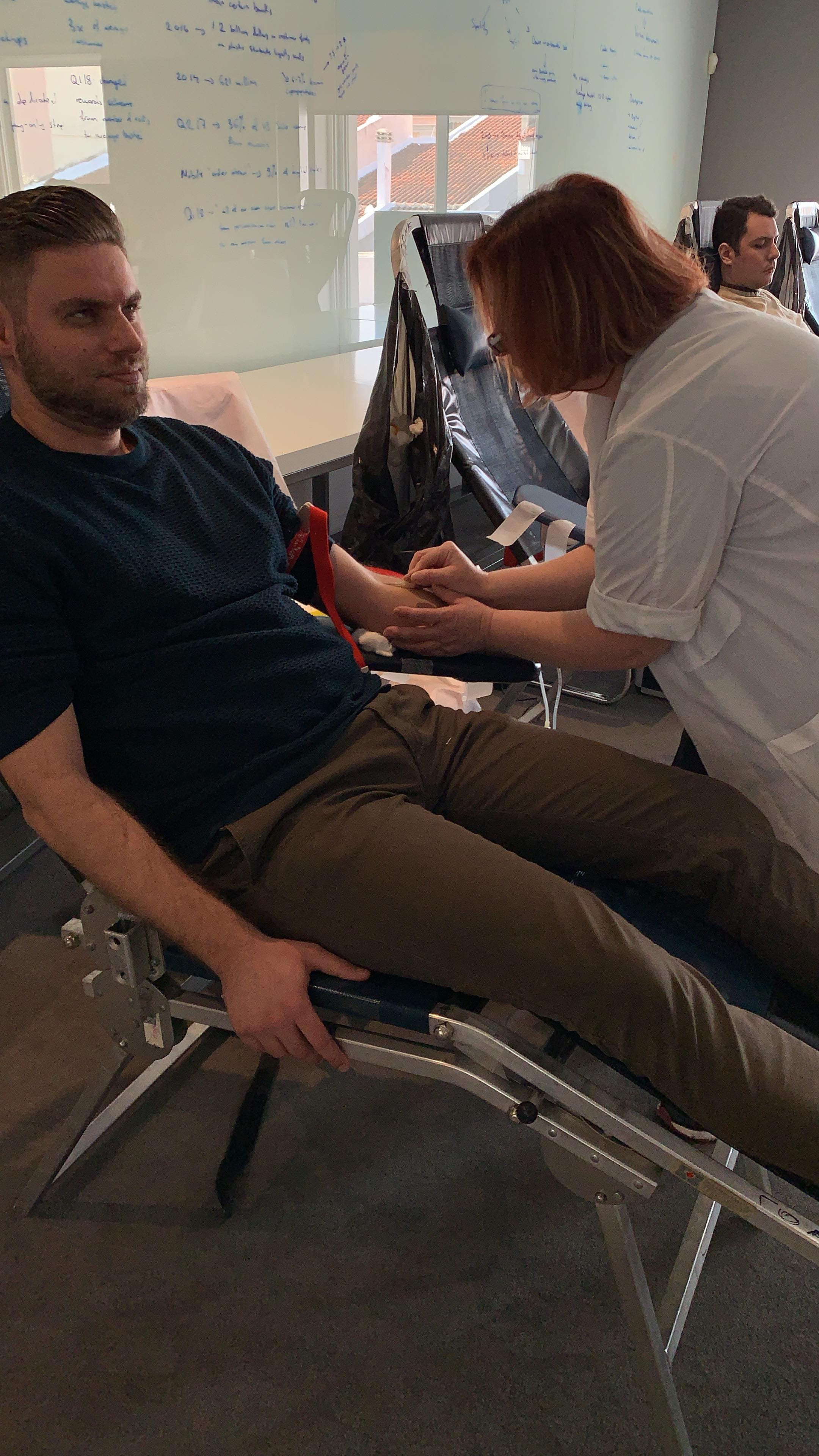An ATCOM colleague donating blood