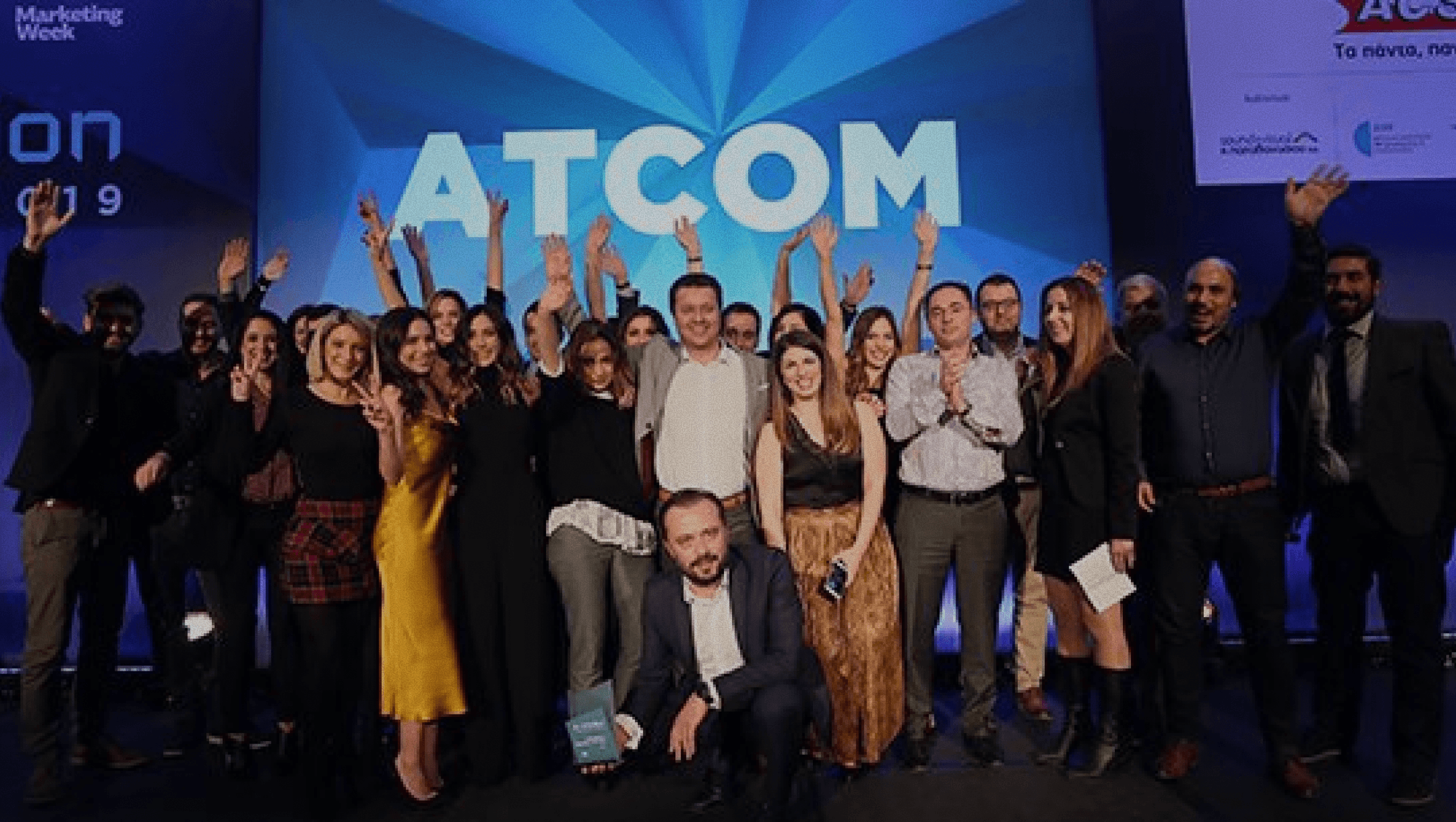 The ATCOM team celebrating at an awards ceremony
